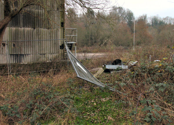 asbestos clad b uilding and fallen fencing Freshford Mill adjoining field with public access