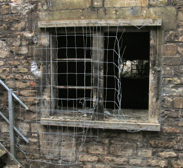 window with poor security measures at Freshford Mill Somerset